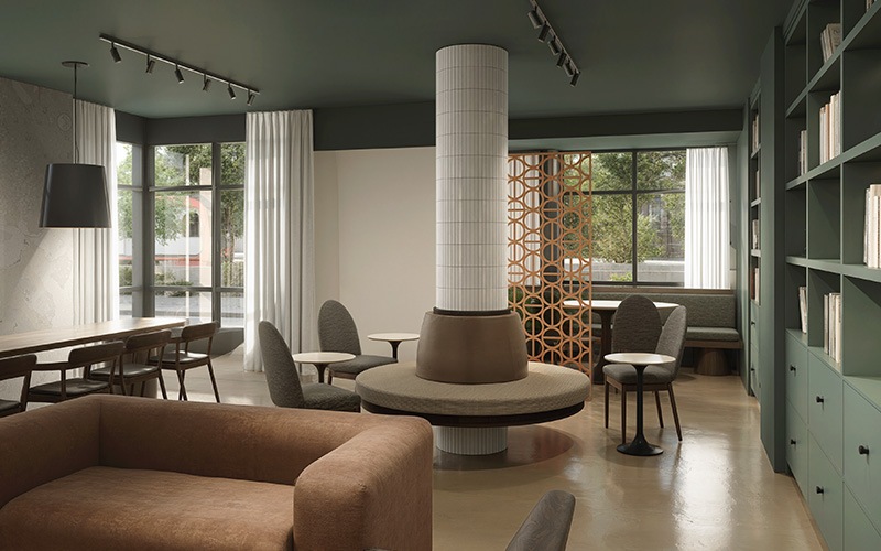 a lounge with seating bookshelf and windows